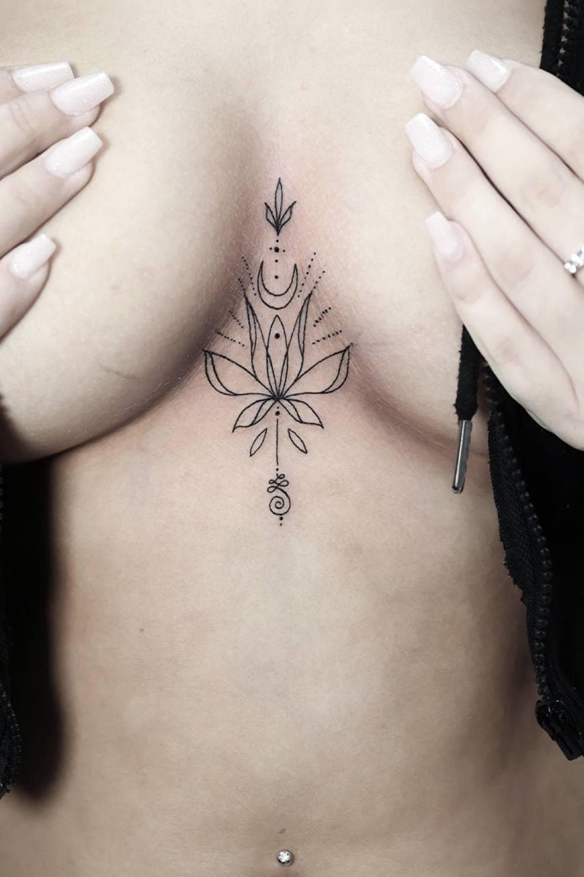 Fine-Line-Tattoo: Lotusmotiv mit Dotwork-Akzenten.